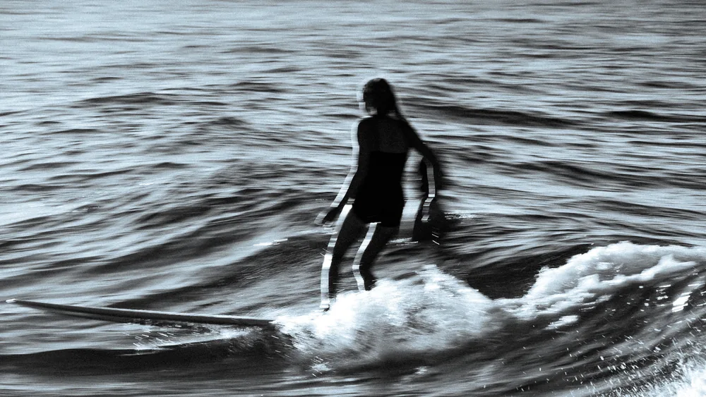A rider on a slow wave, softened by a long exposure, Byron Bay, Australia